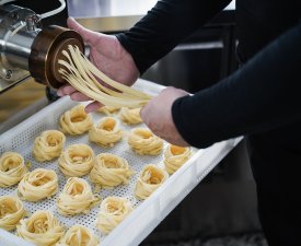 Man working with Pasta manufacture machine