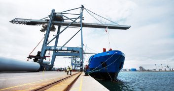 Size ratio. Two customs officer sat work in the shipyard