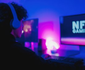 Young gamers buying NFT with token on marketplace platform for metaverse video game - Crypto technology trends - Focus on computer monitor